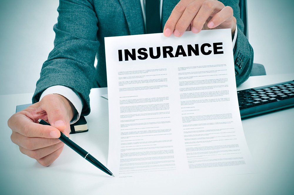 man in suit holding an insurance form and a pen for cat insurance